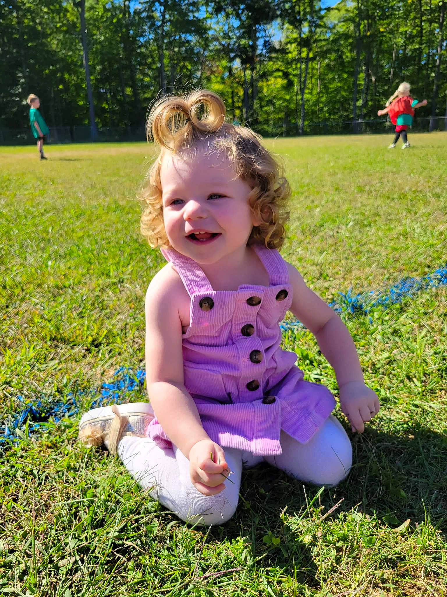 Olivia is registered to the contest to win money with this photo: baby_toddler_clothing, botany, fun, grass, grass_family, grassland, green, happy, joy, leisure, meadow, natural_environment, nature, people_in_nature, person, pink, plant, recreation, smile, sunlight