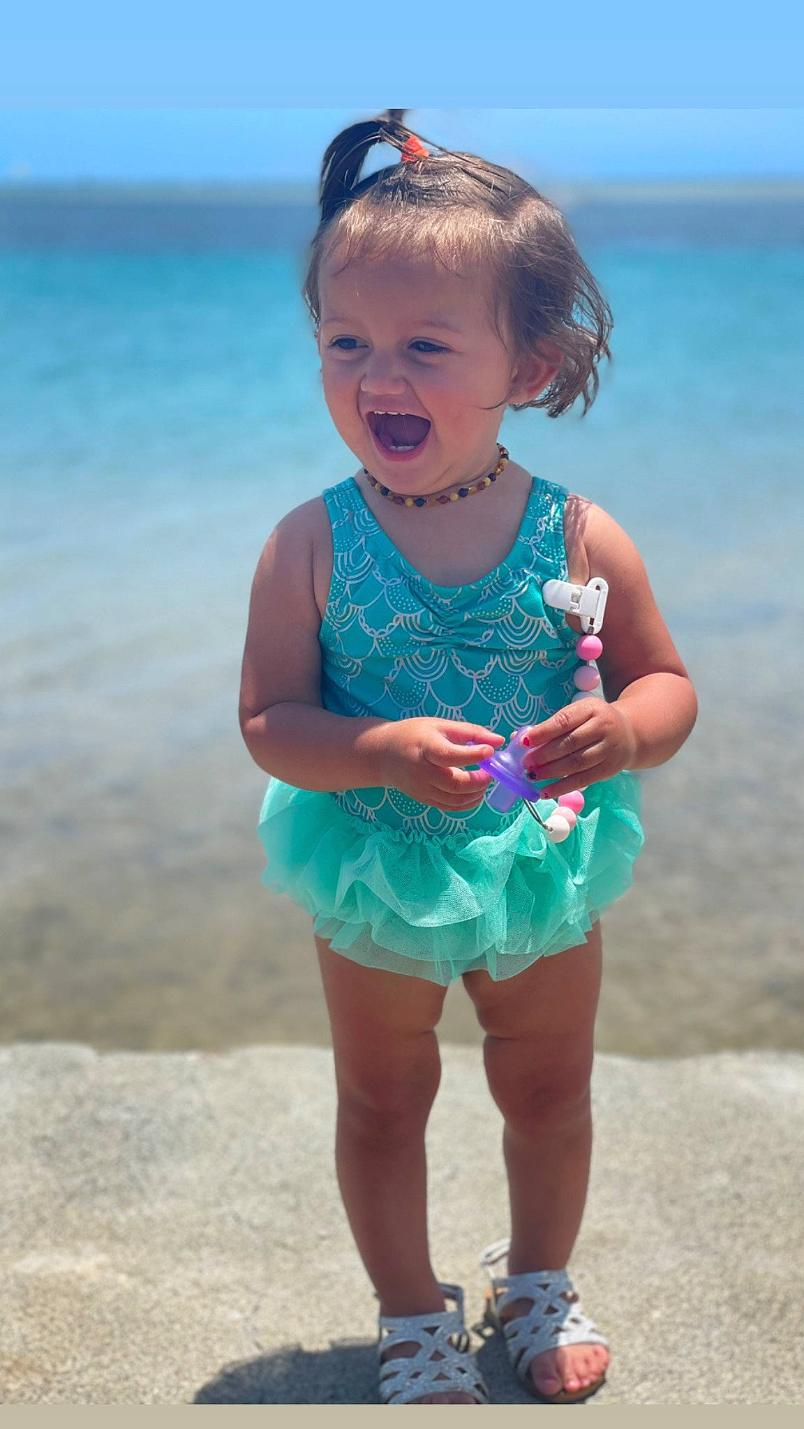 Bayley joined the competition — help win amazing prizes! azure, baby_toddler_clothing, beach, blue, child, dress, eye, face, facial_expression, fun, hairstyle, happy, head, iris, person, pink, shoulder, skin, sky, toddler