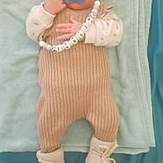 Jessim participe au concours pour gagner de l'argent avec cette photo : baby, pacifier, knitwear, blanket, towel, sleeping, infant, person, cozy, cute, bead_chain, hand, footwear, soft_texture, indoor, child, sleep, headwear, clothing, closeup