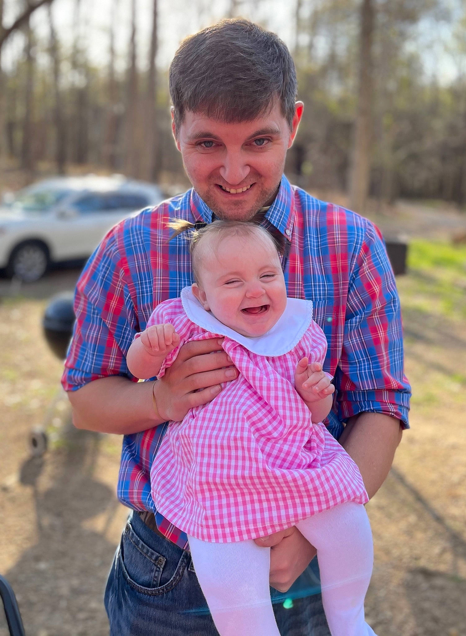Mila Grace joined the competition — help win amazing prizes! baby, facial_expression, fun, gesture, grass, happy, interaction, joy, leisure, pattern, people_in_nature, person, pink, plaid, plant, recreation, smile, tartan, tire, toddler