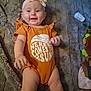 Brooklyn joined the competition — help win amazing prizes! baby, infant, smiling, headband, onesie, orange_clothing, blanket, toy, bottle, happy, cute, child, person, indoors, lying_down, portrait, soft_texture, baby_accessory, cheerful, small_child