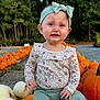 autumn, baby, bow, child, crying, fall, floral_shirt, gravel, green_pants, headband, nature, outdoor, person, plants, pumpkin, pumpkin_patch, sad_face, seasonal, toddler, trees