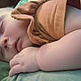 Brooklyn is registered to the contest to win money with this photo: baby, sleeping, infant, closeup, peaceful, hand, face, skin, orange_clothing, blanket, rest, nap, child, soft_light, indoors, cute, chubby, calm, portrait, young