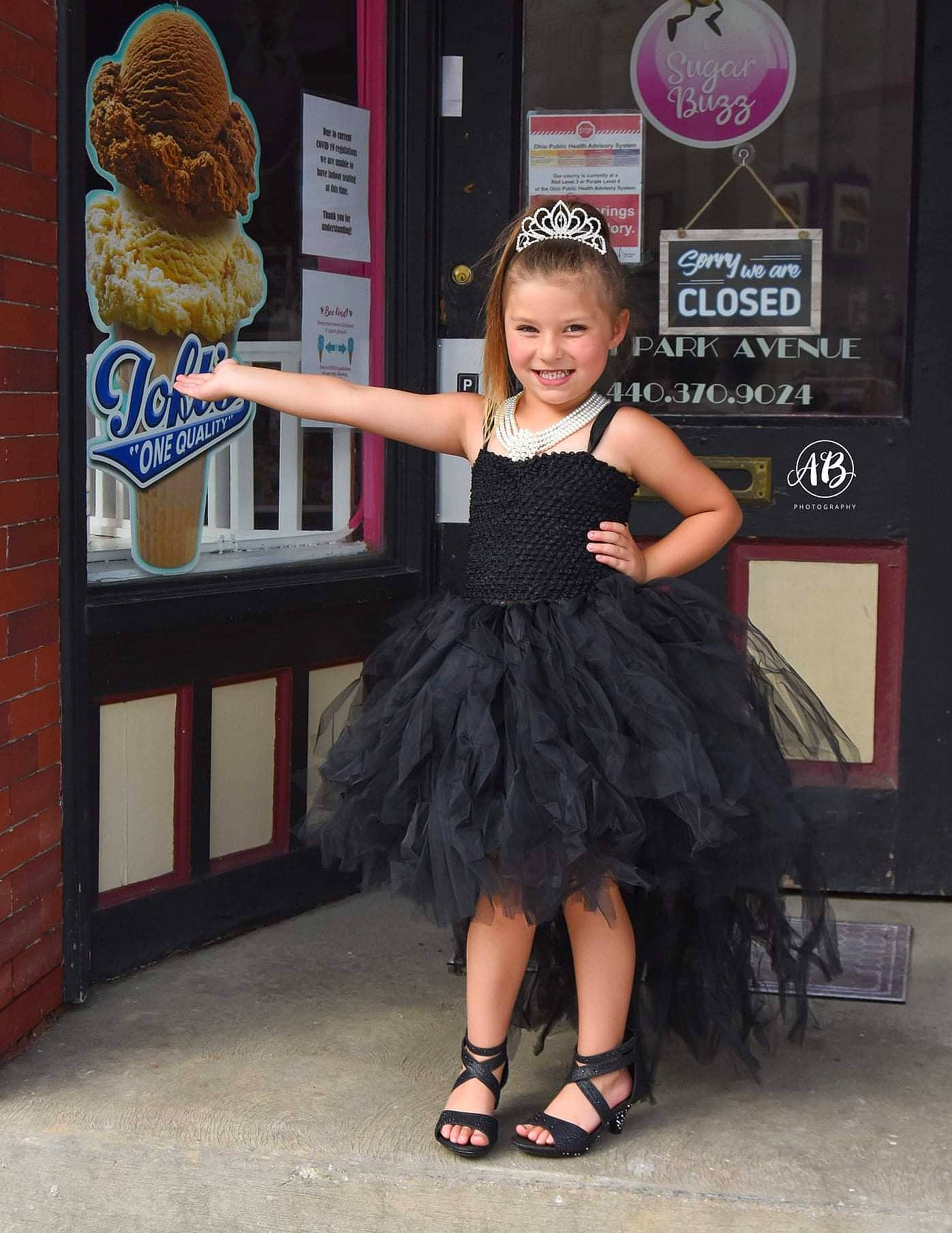 Vanellope is registered to the contest to win money with this photo: cocktail_dress, costume, day_dress, electric_blue, event, fashion_accessory, fashion_design, flooring, formal_wear, fun, happy, hat, joy, logo, magenta, mammal, one_piece_garment, person, sandal, smile