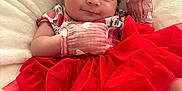 Scarlett is registered to the contest to win money with this photo: baby, infant, smile, red_tutu, headband, mittens, blanket, cute, portrait, clothing, sleepy, soft_texture, indoor, person, fashion, newborn, happy, resting, adorable, child
