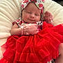 Scarlett is registered to the contest to win money with this photo: baby, infant, smile, red_tutu, headband, mittens, blanket, cute, portrait, clothing, sleepy, soft_texture, indoor, person, fashion, newborn, happy, resting, adorable, child