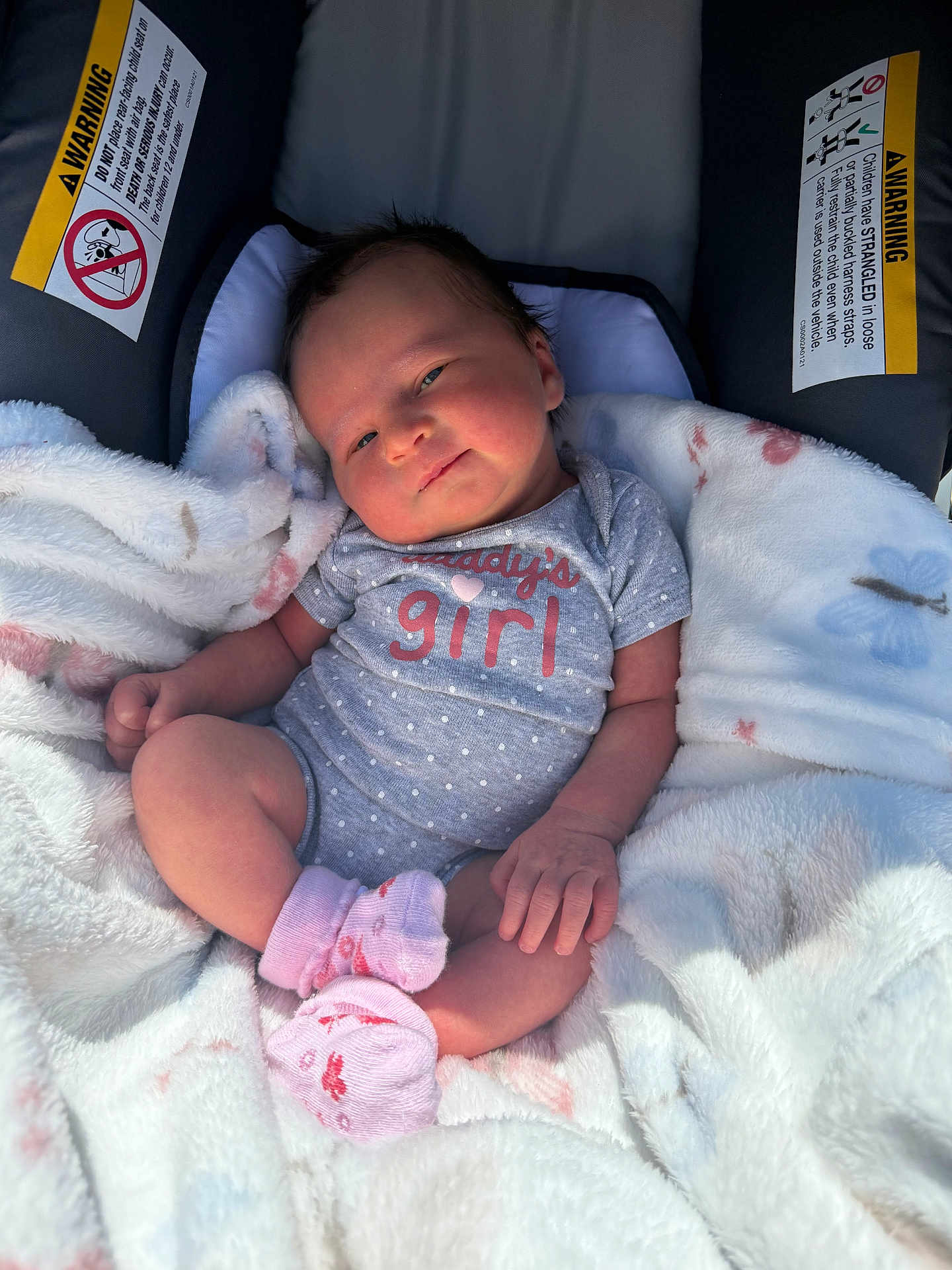 Scarlett is registered to the contest to win money with this photo: baby, infant, child, car_seat, blanket, onesie, pink_socks, smile, face, cute, cozy, soft, indoors, clothing, newborn, resting, comfort, happy, portrait, baby_girl