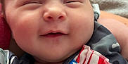 Scarlett is registered to the contest to win money with this photo: baby, button, child, closeup, clothing, cute, fabric, face, happy, indoor, infant, pacifier, pattern, person, portrait, sleepy, smiling, soft, stars, stripes