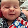 baby, smiling, face, infant, clothing, pattern, button, stars, stripes, fabric, pacifier, closeup, cute, soft, child, sleepy, portrait, indoor, person, happy