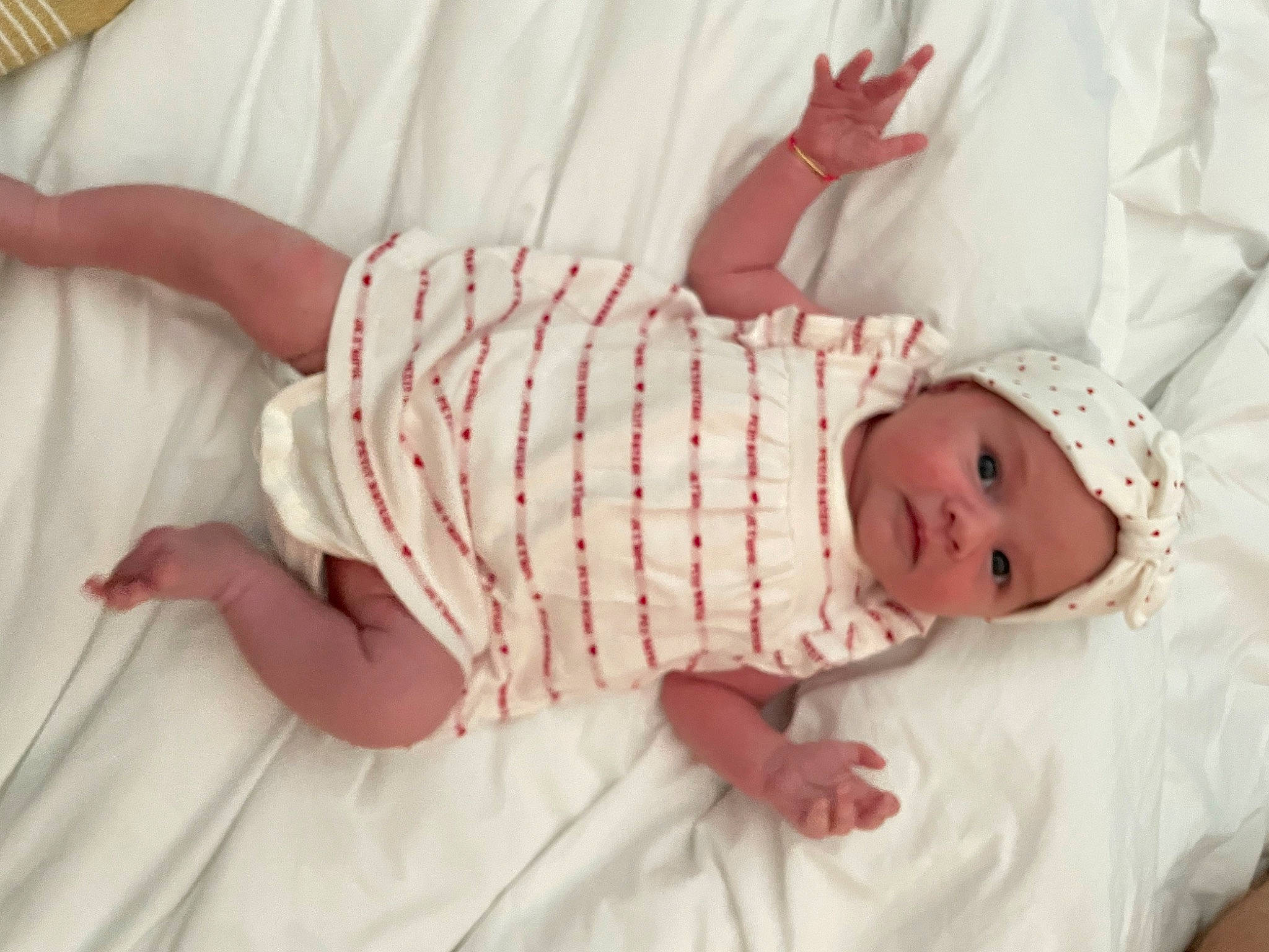 Ava participe au concours pour gagner de l'argent avec cette photo : baby, baby_products, baby_sleeping, baby_toddler_clothing, child, comfort, embellishment, fashion_accessory, finger, hat, headgear, headwear, linens, pattern, person, pink, skin, sleeve, textile, toddler