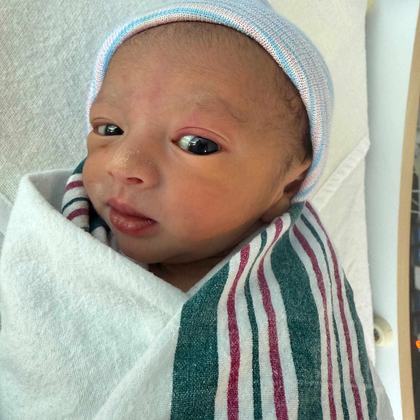 Kazi Zayan Ali joined the competition — help win amazing prizes! baby, blanket, child, closeup, cute, expression, eyes, face, hat, hospital, indoors, infant, newborn, newborn_baby, person, portrait, skin, striped, swaddled, wrapped