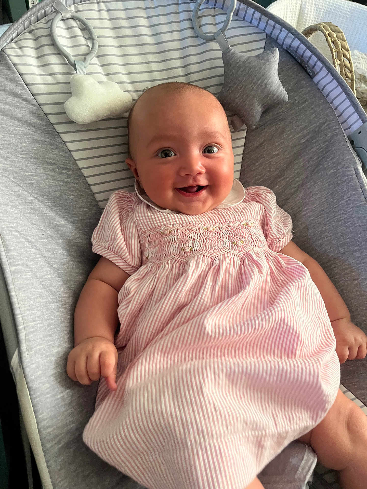 Rosa joined the competition — help win amazing prizes! baby, infant, smiling, dress, pink, striped, baby_rocker, cushion, soft_toys, face, happy, child, person, indoor, cute, comfort, relaxing, young, portrait, clothing
