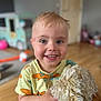 Freddie joined the competition — help win amazing prizes! toddler, child, smiling, face, blue_eyes, blond_hair, scratches, plush_toy, indoor, wooden_floor, toy_car, yellow_shirt, short_sleeves, happy, person, portrait, playroom, blurred_background, holding, cute