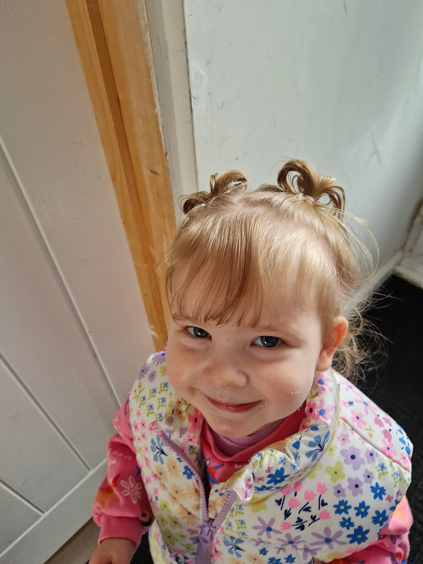 Delilah is registered to the contest to win money with this photo: blonde, bodypart, child, clothing, coat, door, face, female, finger, girl, hair, hand, happy, head, person, photography, plywood, portrait, smile, wood