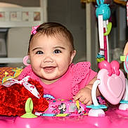 Audrey joined the competition — help win amazing prizes! activity_center, baby, bow, cheerful, child, closeup, colorful, cute, decor, face, happy, indoor, infant, person, pink_clothing, plastic, play, smiling, toy, young_child