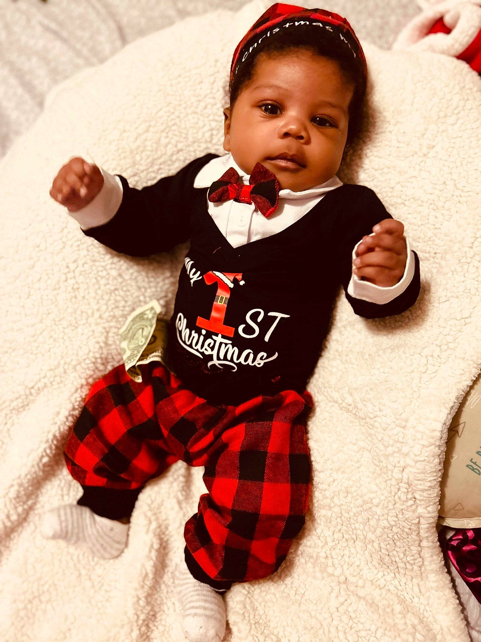 Damari joined the competition — help win amazing prizes! baby, baby_toddler_clothing, carmine, child, collar, comfort, face, finger, happy, hat, linens, pattern, person, plaid, sitting, sleeve, sock, t_shirt, tartan, thigh