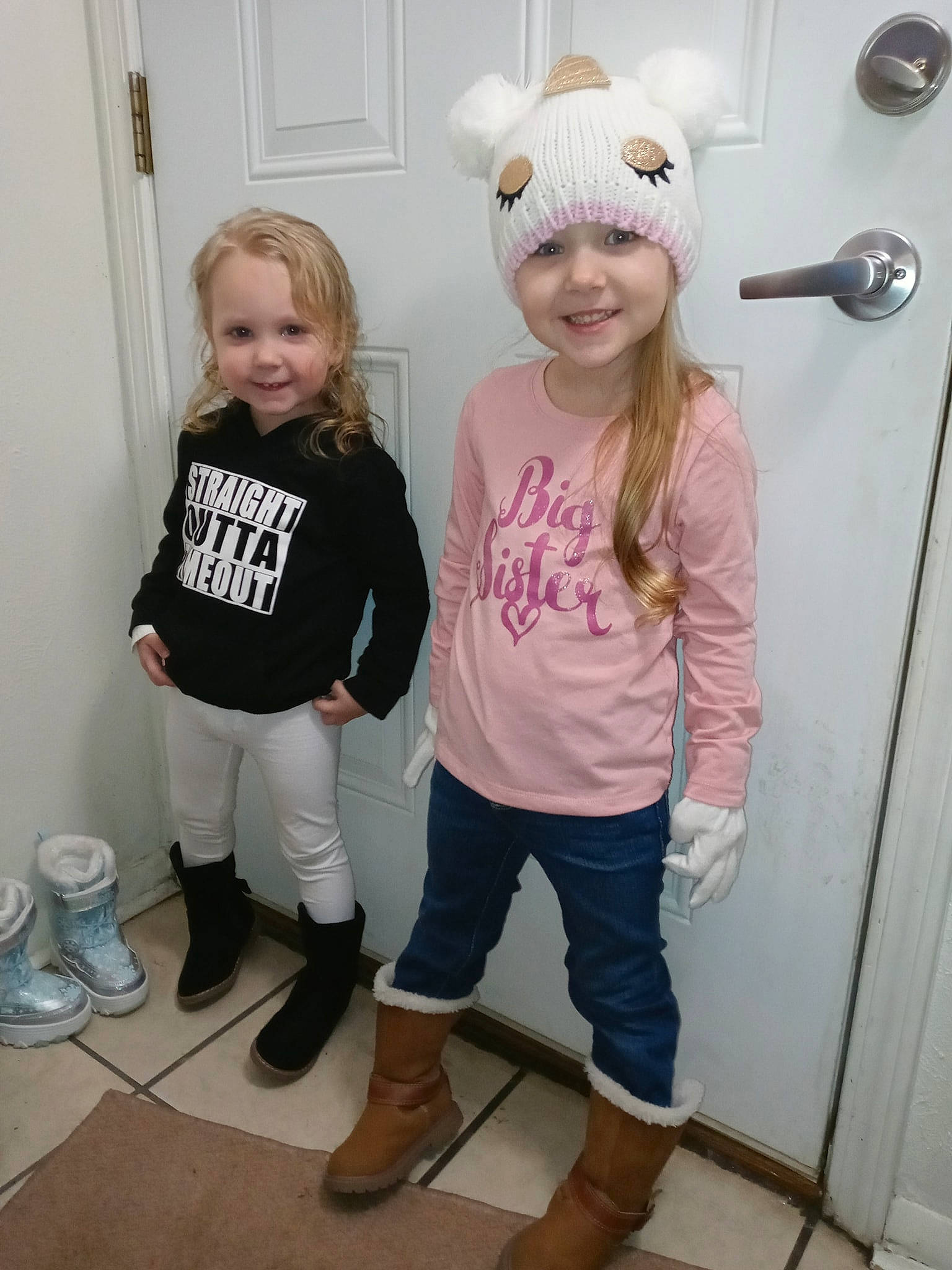 Remi is registered to the contest to win money with this photo: baby_toddler_clothing, blond, child, door, event, fun, hair, happy, headwear, joint, joy, leg, person, pink, shoe, sleeve, smile, sneakers, standing, t_shirt