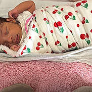 Larissa joined the competition — help win amazing prizes! newborn, baby, sleeping, blanket, cherry_pattern, swaddled, soft_bedding, pink, white, peaceful, infant, cute, resting, indoors, child, portrait, cozy, wrapped, toddler, face