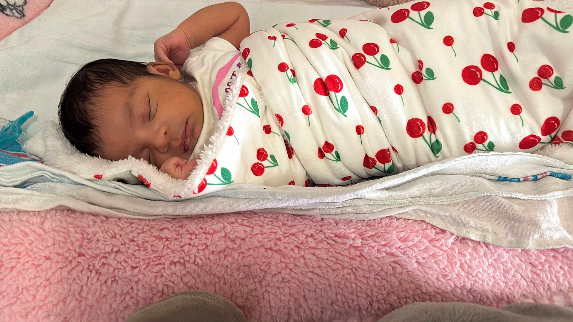 Larissa joined the competition — help win amazing prizes! newborn, baby, sleeping, blanket, cherry_pattern, swaddled, soft_bedding, pink, white, peaceful, infant, cute, resting, indoors, child, portrait, cozy, wrapped, toddler, face