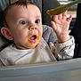 baby, baby_food, bib, clothing, drool, ear, expression, face, feeding, hand, high_chair, infant, mealtime, messy, mouth, plastic_tray, portrait, spoon, surprised, wide_eyes