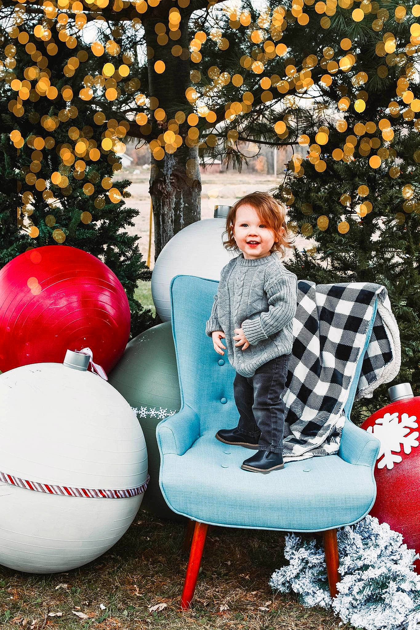 Foster is registered to the contest to win money with this photo: branch, chair, eye, face, fun, hair, happy, head, human_body, joy, leaf, leisure, lighting, nature, outerwear, people_in_nature, person, plant, red, standing