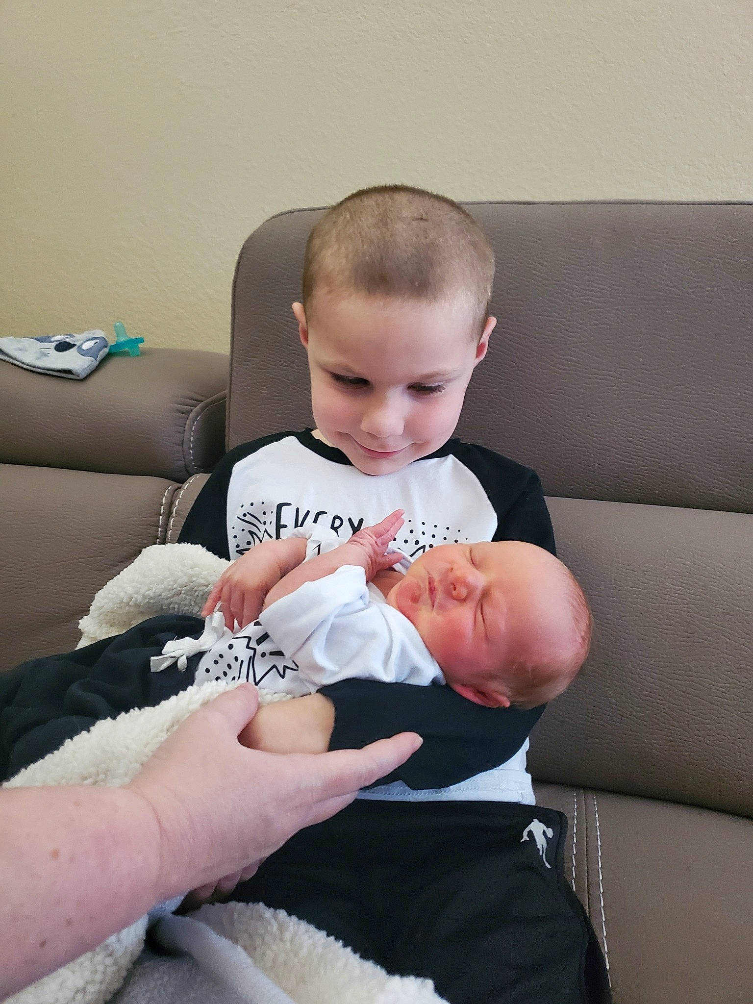 Dustin is registered to the contest to win money with this photo: abdomen, arm, baby_toddler_clothing, barefoot, comfort, couch, elbow, finger, foot, hand, human_body, knee, lap, leg, person, shoulder, sock, stomach, thigh, toddler