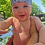 baby, child, bandana, outdoor, smiling, happy, skin, hand, arm, nature, tree, sunlight, diaper, grass, person, summer, blue_sky, closeup, portrait, daylight