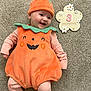 baby, infant, pumpkin_costume, orange, green, striped_clothing, smiling, lying_down, carpet, 3_months_sign, flower_shape, cute, happy, holiday_costume, child, portrait, festive, indoors, costume, seasonal