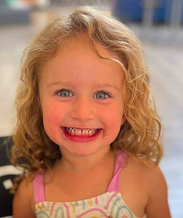 Bailey is registered to the contest to win money with this photo: cheek, chin, eye, eyebrow, eyelash, face, fun, grass, happy, iris, joy, leisure, lip, mouth, neck, nose, person, pink, skin, smile