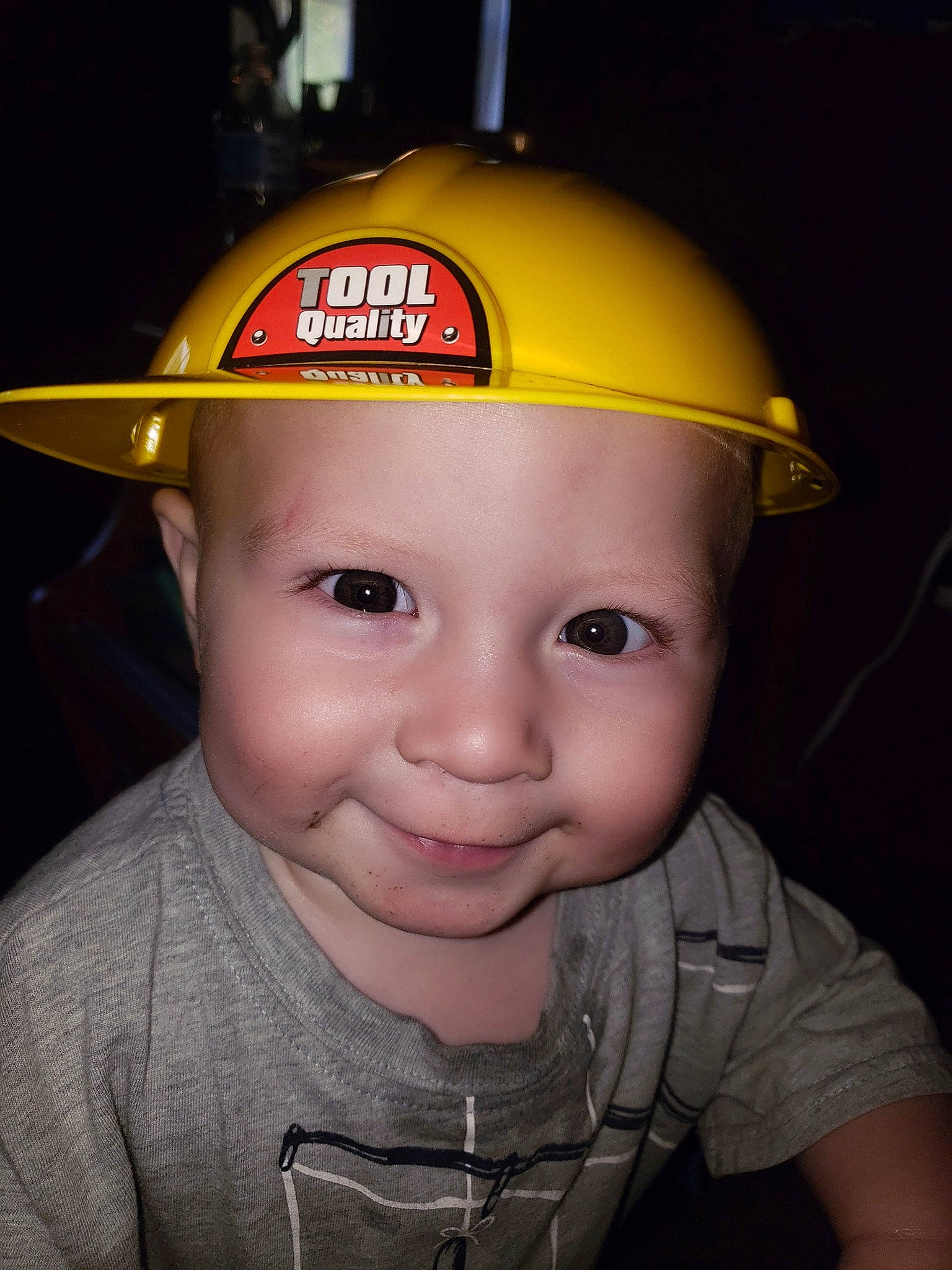 Axton is registered to the contest to win money with this photo: cap, child, clothing, fashion_accessory, fun, hard_hat, hat, headgear, headwear, helmet, joy, person, personal_protective_equipment, smile, toddler, yellow