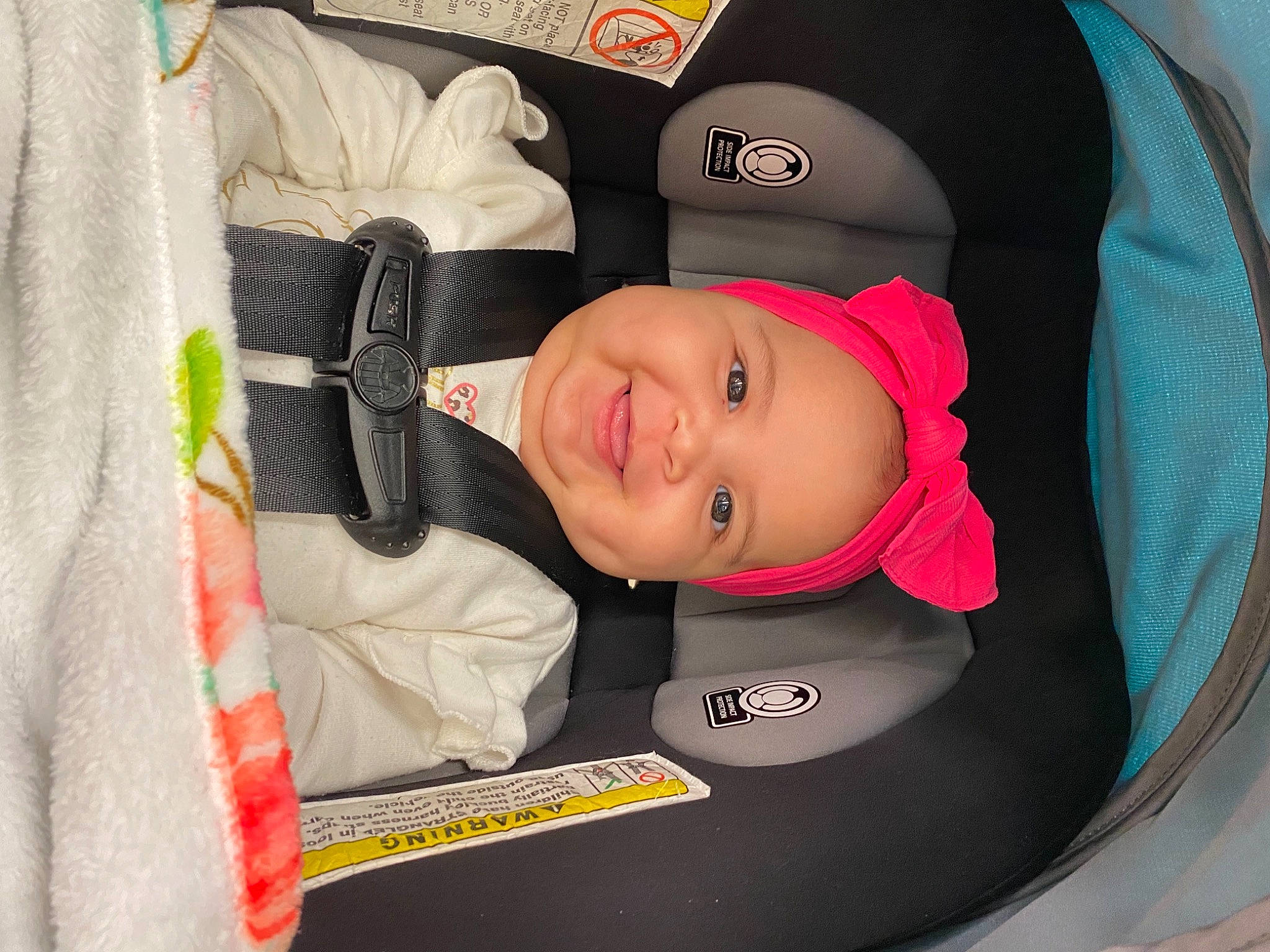 Vivianna is registered to the contest to win money with this photo: auto_part, baby, baby_carriage, baby_products, baby_toddler_clothing, car_seat, child, circle, comfort, fun, hat, headgear, headwear, joy, person, personal_protective_equipment, product, sleeve, smile, toddler