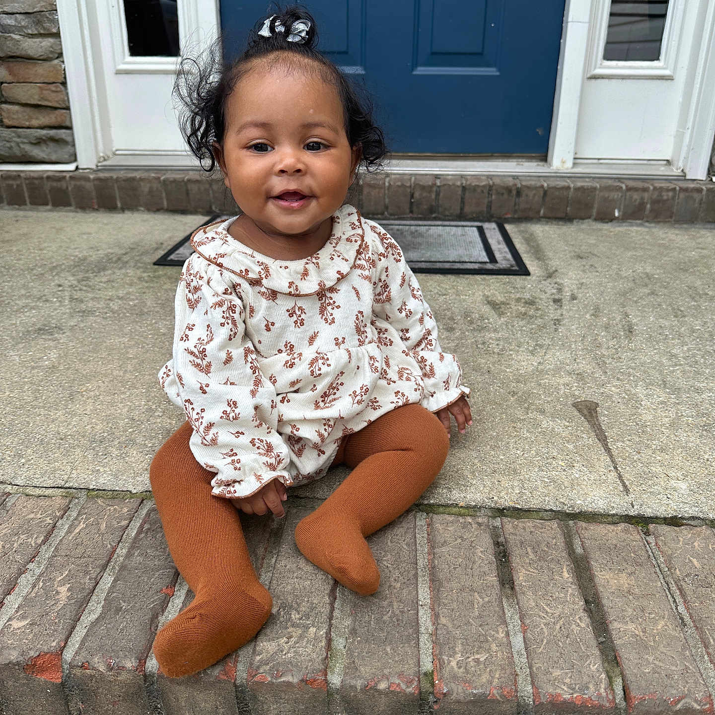 Kai'Lani is registered to the contest to win money with this photo: brick, child, clothing, door, dress, face, female, girl, hardwood, head, pants, path, person, photography, portrait, road, sitting, slate, walkway, wood