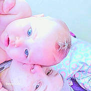 Rayne joined the competition — help win amazing prizes! adult, baby, blanket, blue_eyes, child, closeup, cuddle, expression, face, head, human, indoor, intimacy, love, overexposed, parent, pattern, portrait, skin, soft_light