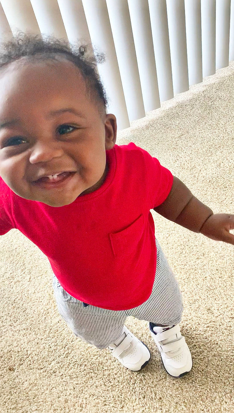 Hakeem is registered to the contest to win money with this photo: arm, baby, cheek, child, face, facial_expression, fun, happy, head, joy, laugh, lip, mouth, nose, outerwear, person, play, sitting, skin, smile