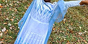 Miss Naomi is registered to the contest to win money with this photo: child, girl, princess_costume, tiara, dress, blue, white, outdoor, grass, leaves, autumn, nature, celebration, smiling, happy, arms_raised, footwear, greenery, playful, person