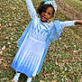 child, girl, princess_costume, tiara, dress, blue, white, outdoor, grass, leaves, autumn, nature, celebration, smiling, happy, arms_raised, footwear, greenery, playful, person