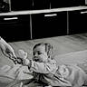 Luna a rejoint le concours — aidez-le/la à gagner de superbes lots ! baby, black_and_white, blanket, child, clothing, comfort, crawling, cute, floor, hand, home, indoor, infant, interaction, person, playful, smiling, sock, soft, toy