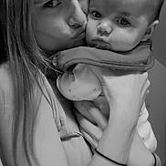 Luna participe au concours pour gagner de l'argent avec cette photo : woman, baby, child, face, portrait, black_and_white, affection, kiss, holding, indoor, person, close_up, hair, clothing, hand, expression, toddler, candid, emotion, family
