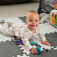 Jacob joined the competition — help win amazing prizes! baby, child, smiling, onesie, toy, playmat, floor, indoor, crawling, happy, face, person, playpen, colorful, cute, infant, young_child, home, toddler, bright