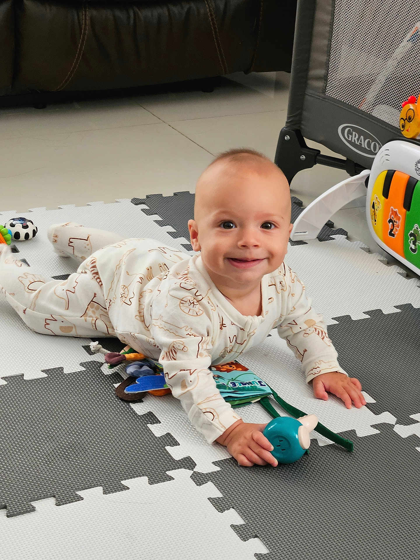 Jacob joined the competition — help win amazing prizes! baby, child, smiling, onesie, toy, playmat, floor, indoor, crawling, happy, face, person, playpen, colorful, cute, infant, young_child, home, toddler, bright