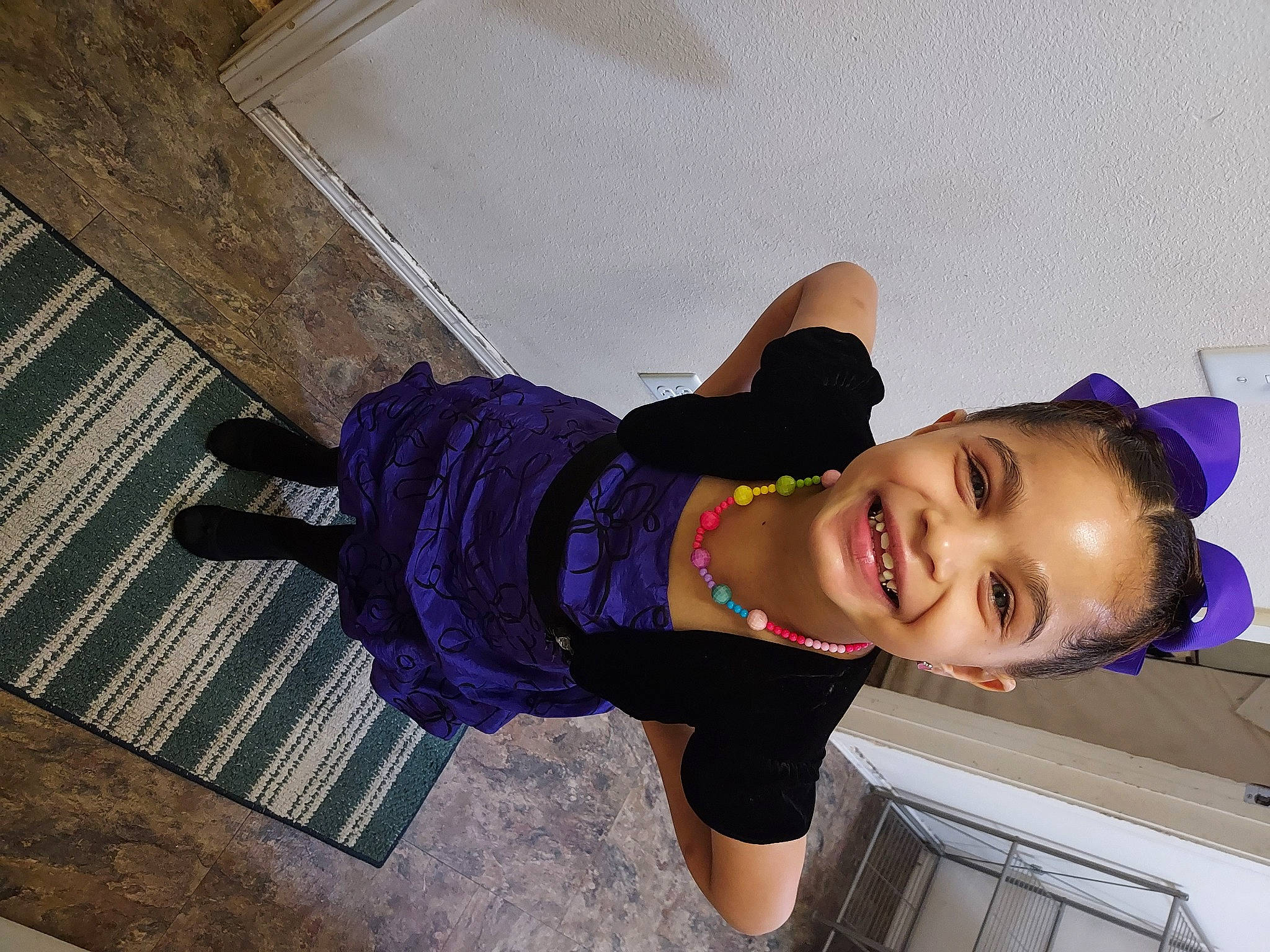 Nevaeh is registered to the contest to win money with this photo: child, electric_blue, flooring, fun, happy, hat, human_leg, joy, knee, leisure, magenta, person, purple, smile, sock, sportswear, thigh, toddler, vacation, waist