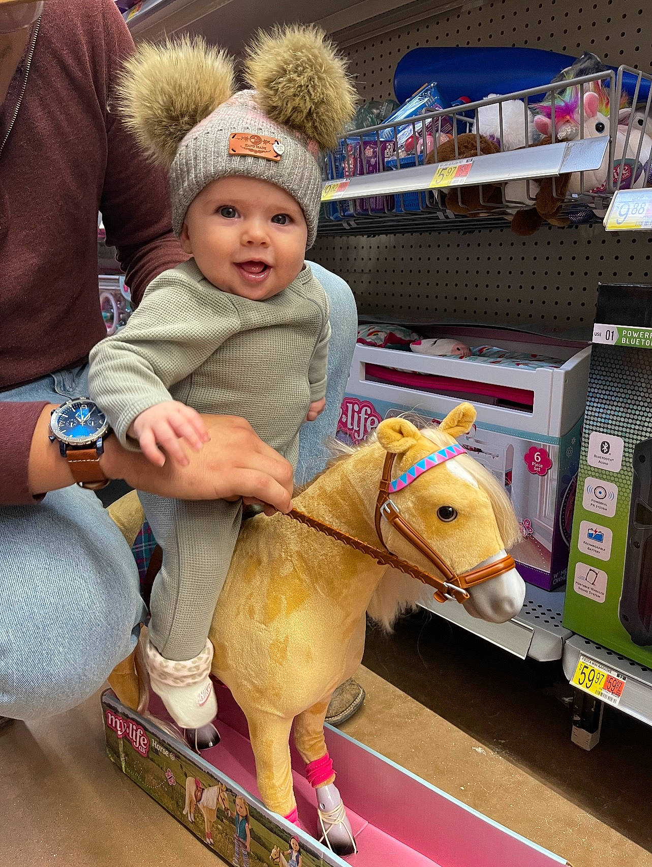 Novalyn joined the competition — help win amazing prizes! baby, cap, child, event, flooring, fun, headwear, horse, horse_tack, human_leg, lap, leg, leisure, person, recreation, retail, sitting, stuffed_toy, toddler, toy