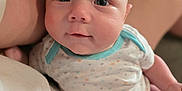 Teagan is registered to the contest to win money with this photo: arm, baby, child, closeup, clothing, comfort, cute, eyes, face, indoor, infant, lap, legs, onesie, pattern, person, portrait, skin, soft_focus, star