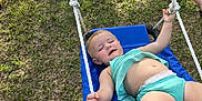 Raelynn is registered to the contest to win money with this photo: barefoot, blue_swing, carefree, child, clothing, family, fun, grass, happy, kid, leisure, outdoor, person, play, playground, recreation, summer, sunlight, swing, toddler