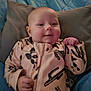 Teagan is registered to the contest to win money with this photo: baby, smiling, infant, onesie, cactus_pattern, blanket, pillow, bed, child, cute, happy, face, hand, soft, sleepwear, young, indoors, portrait, comfort, cozy