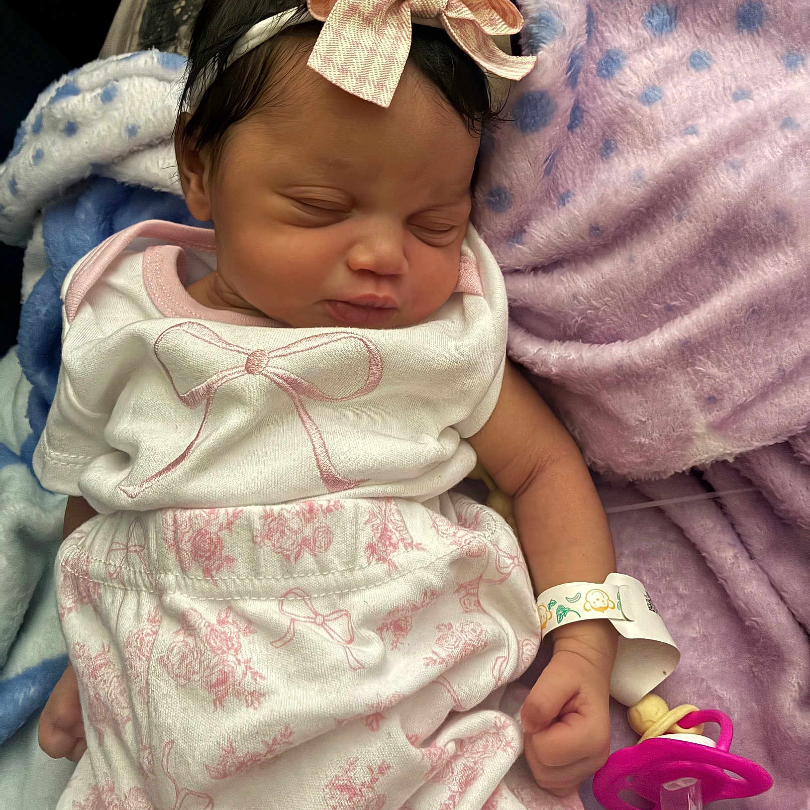 Audree joined the competition — help win amazing prizes! newborn, baby, infant, sleeping, portrait, pink_bow, hair_bow, blanket, plush_blanket, baby_clothing, dress, bib, pacifier, hospital_wristband, lying_down, indoors, close_up, face, child, cozy