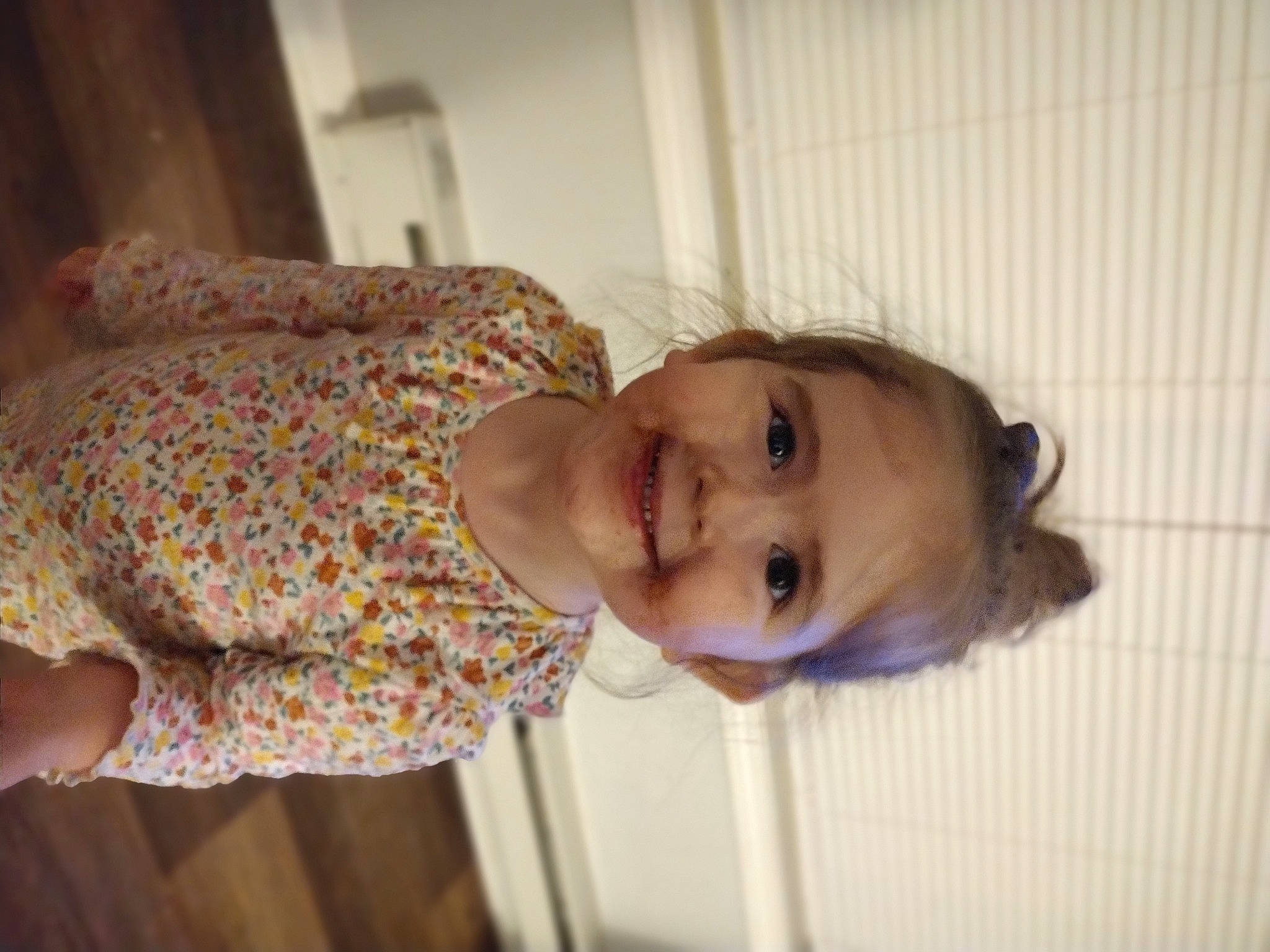 Dahlia is registered to the contest to win money with this photo: baby, baby_products, baby_toddler_clothing, cheek, child, comfort, eyelash, flooring, fun, happy, head, human_body, joy, lip, mouth, nose, person, skin, sleeve, smile