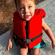Kai joined the competition — help win amazing prizes! child, kid, life_jacket, water, swimming, pool, wet_hair, summer, outdoor, sitting, cute, portrait, sunlight, play, fun, safety, bright_color, expression, legs, young