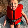 child, kid, life_jacket, water, swimming, pool, wet_hair, summer, outdoor, sitting, cute, portrait, sunlight, play, fun, safety, bright_color, expression, legs, young