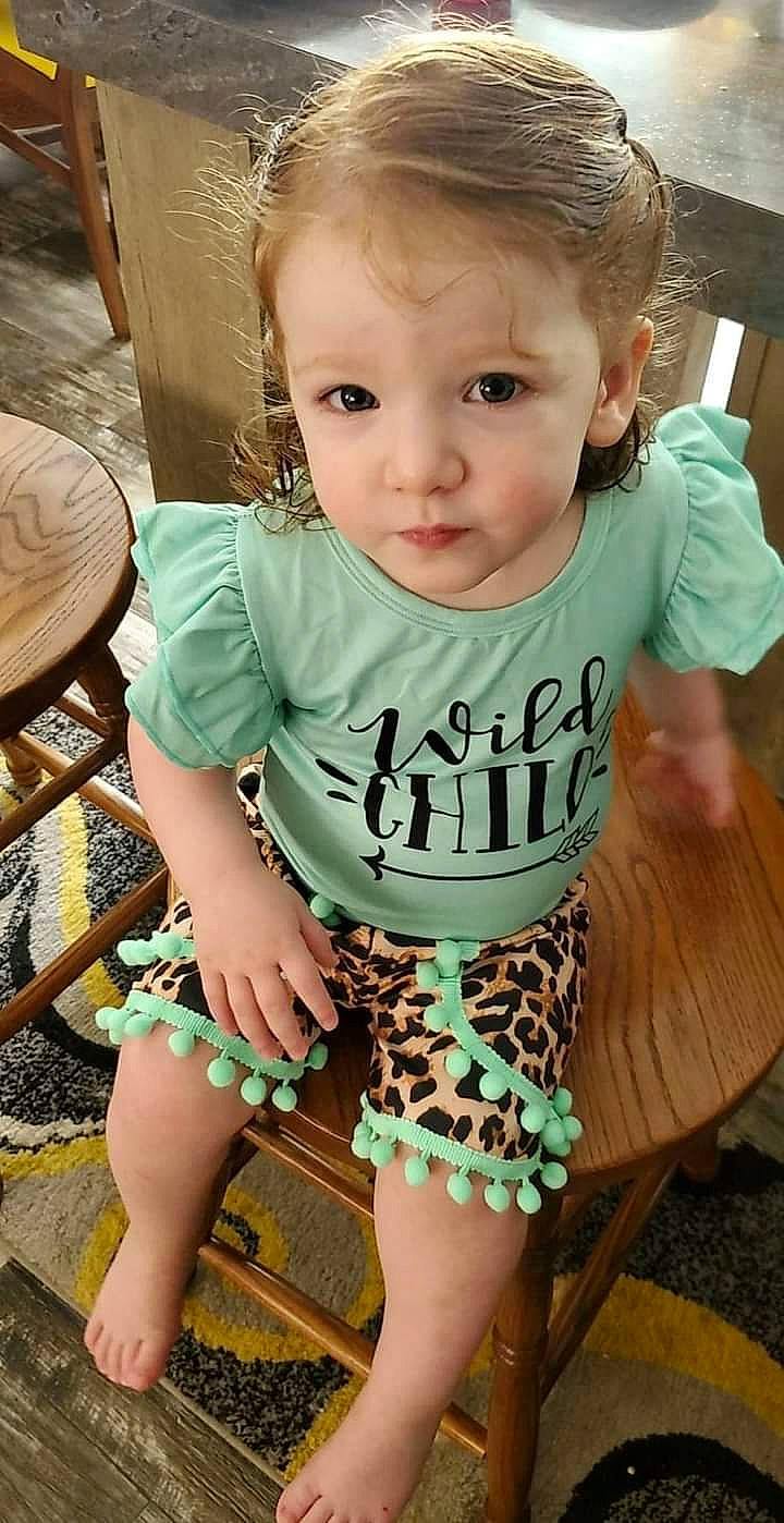 Rosemary is registered to the contest to win money with this photo: baby_toddler_clothing, black, chair, eye, eyelash, face, finger, furniture, green, hair, hairstyle, happy, head, human_body, iris, neck, organ, person, skin, sleeve